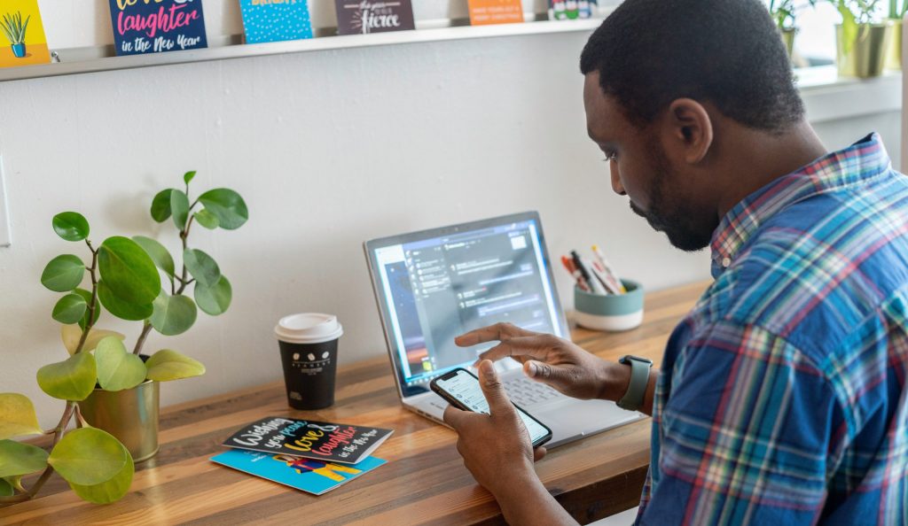 A salesperson working in an office at laptop