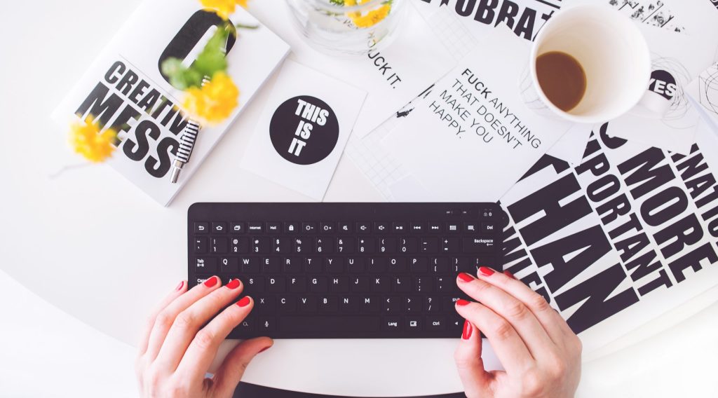 Girl writing on a black keyboard