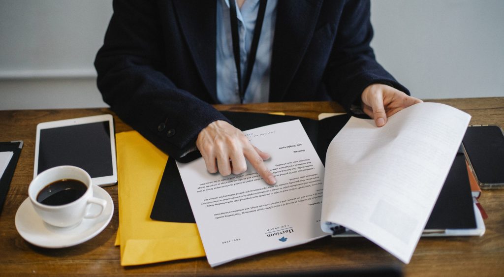 Crop businesswoman working with documents in office