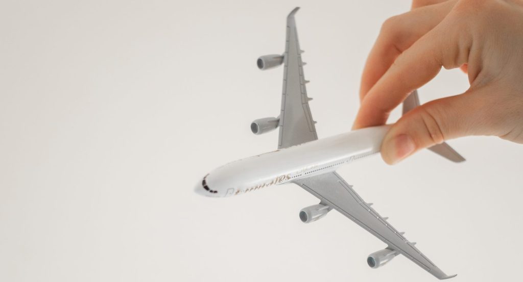 Close up shot of a person holding an airplane toy
