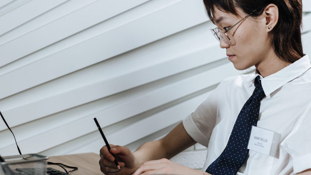 Woman wearing a necktie working on her desk