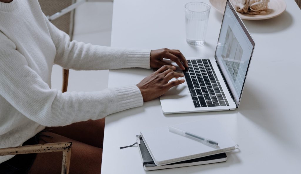 Person in white long sleeve shirt using macbook pro