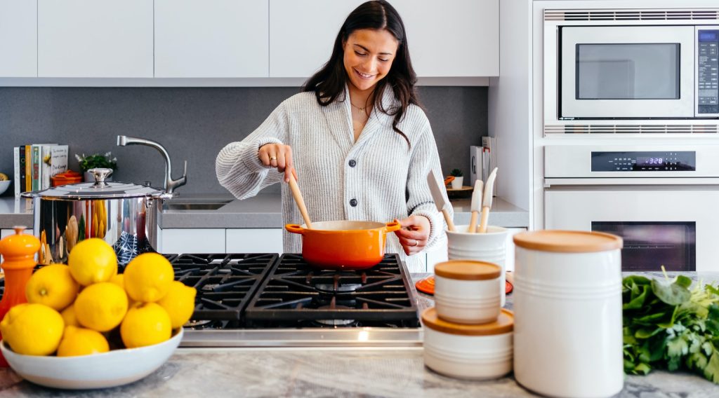 woman cooking inside kitchen room