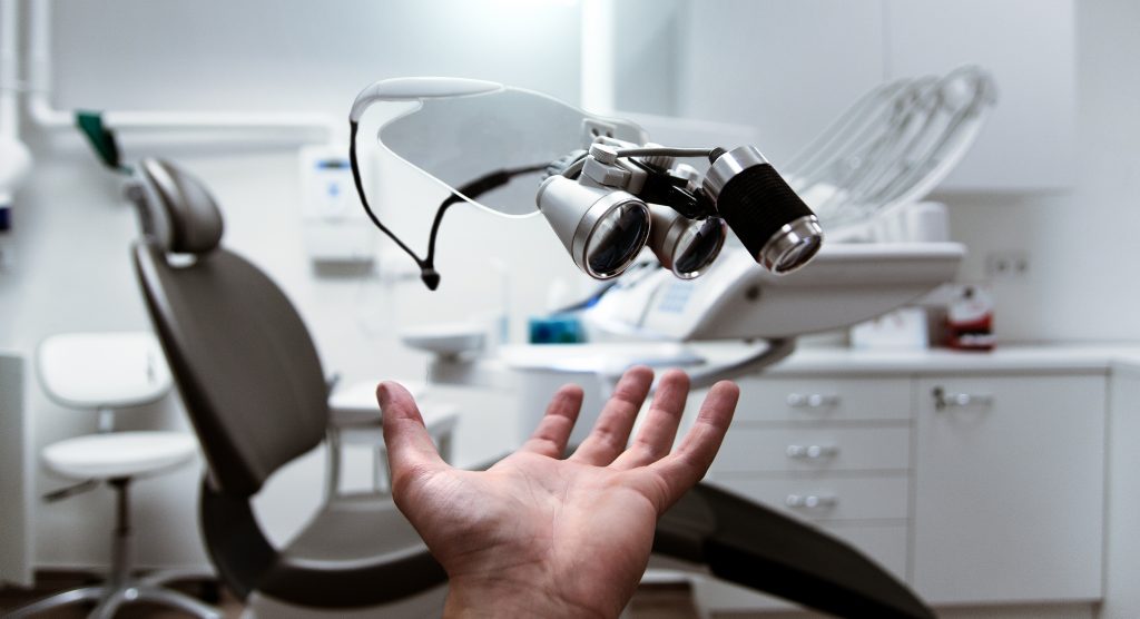 Person showing magnifying eyeglasses