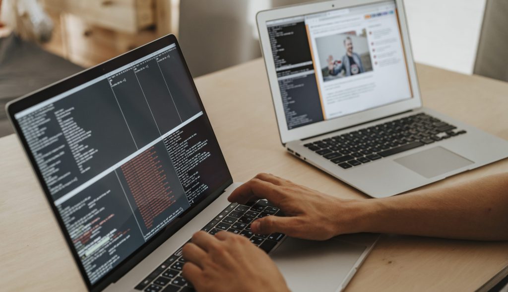 Person coding on a macbook pro